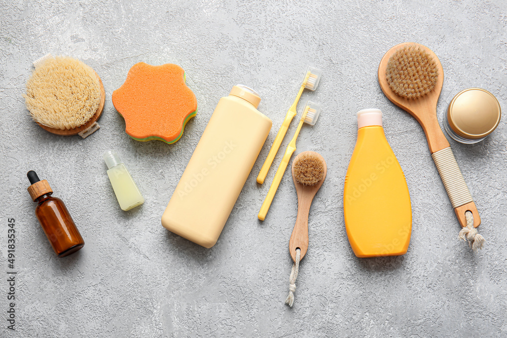 Set of bath accessories and cosmetic products on light background