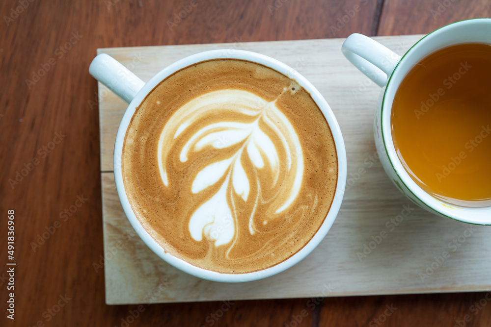 Hot coffee latte a cup of coffee ro cupucino on wood table background with warm morning sunlight con