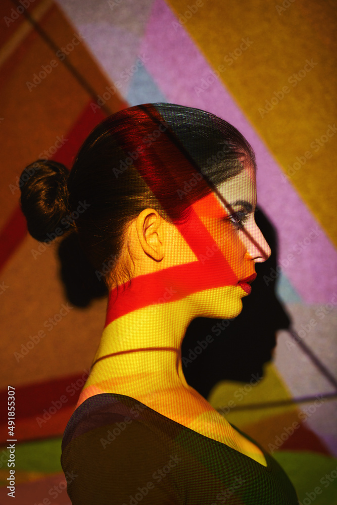 Dont hide behind black and white. A beautiful model in the studio covered with a myriad of abstract 