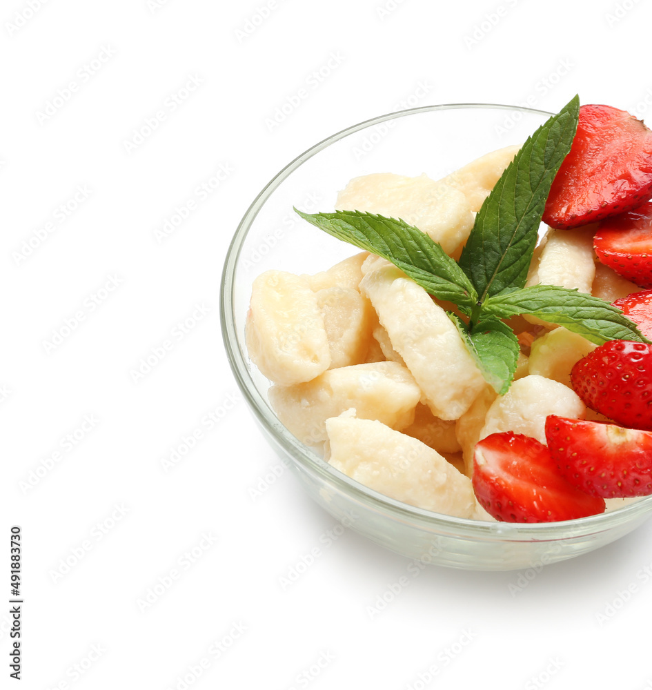 Bowl of delicious lazy dumplings with strawberry on white background, closeup