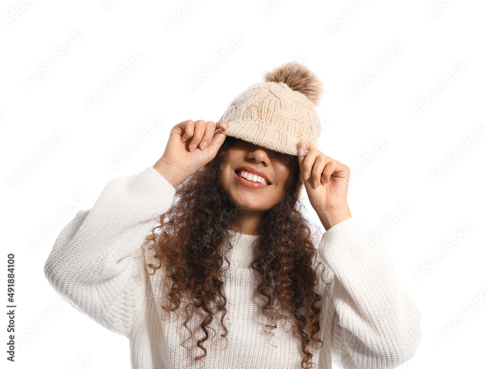 Funny African-American woman in warm clothes on white background