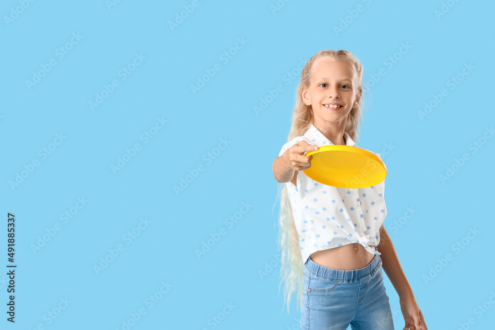 Funny little girl playing frisbee on color background