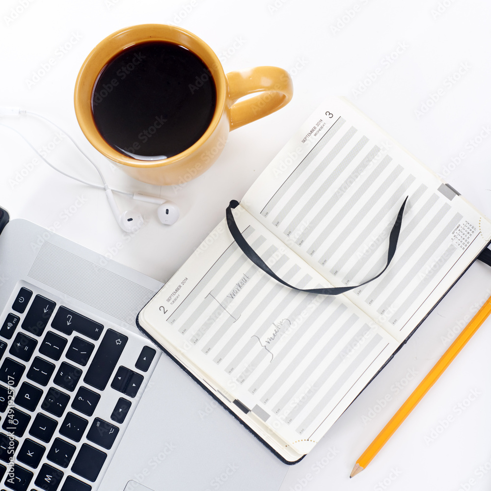 Well prepared for productivity. Shot of a laptop and coffee mug on a table.