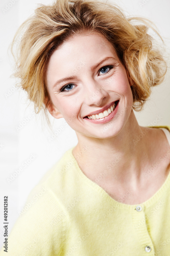 Giving you her best smile. Portrait of an attractive and stylish young woman posing in the studio.