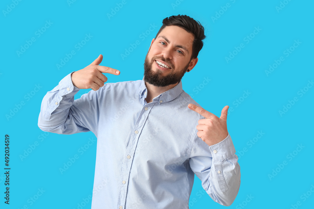 Stylish bearded man on blue background