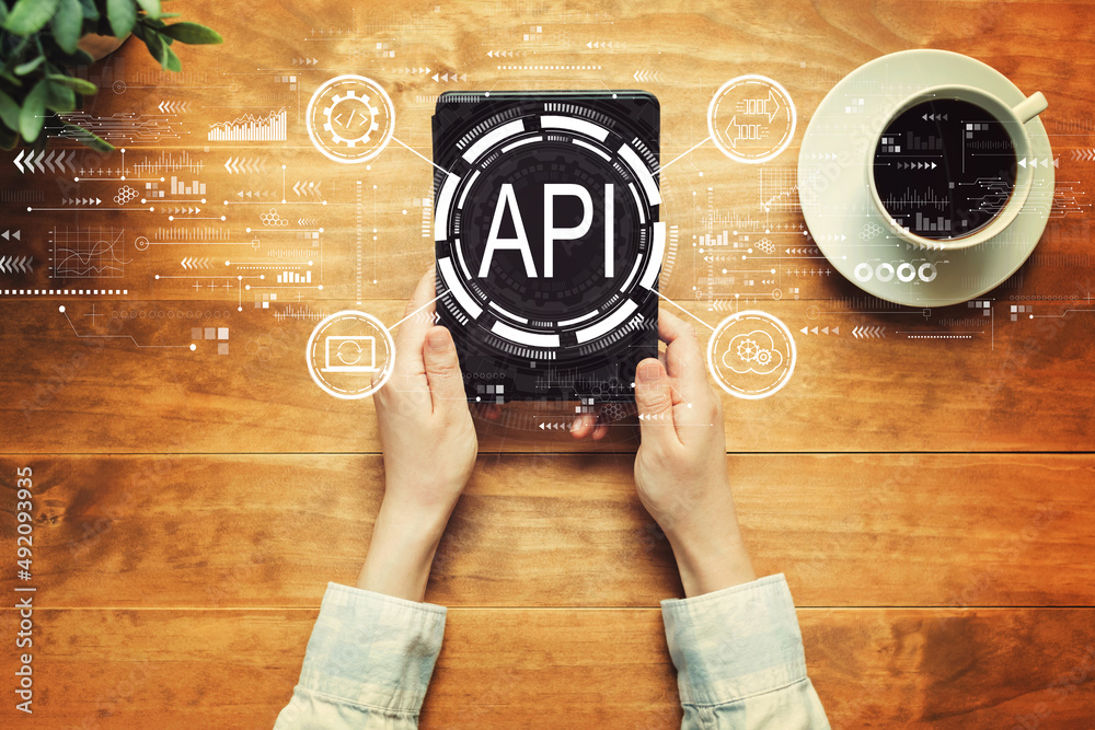 API - application programming interface concept with a person holding a tablet computer
