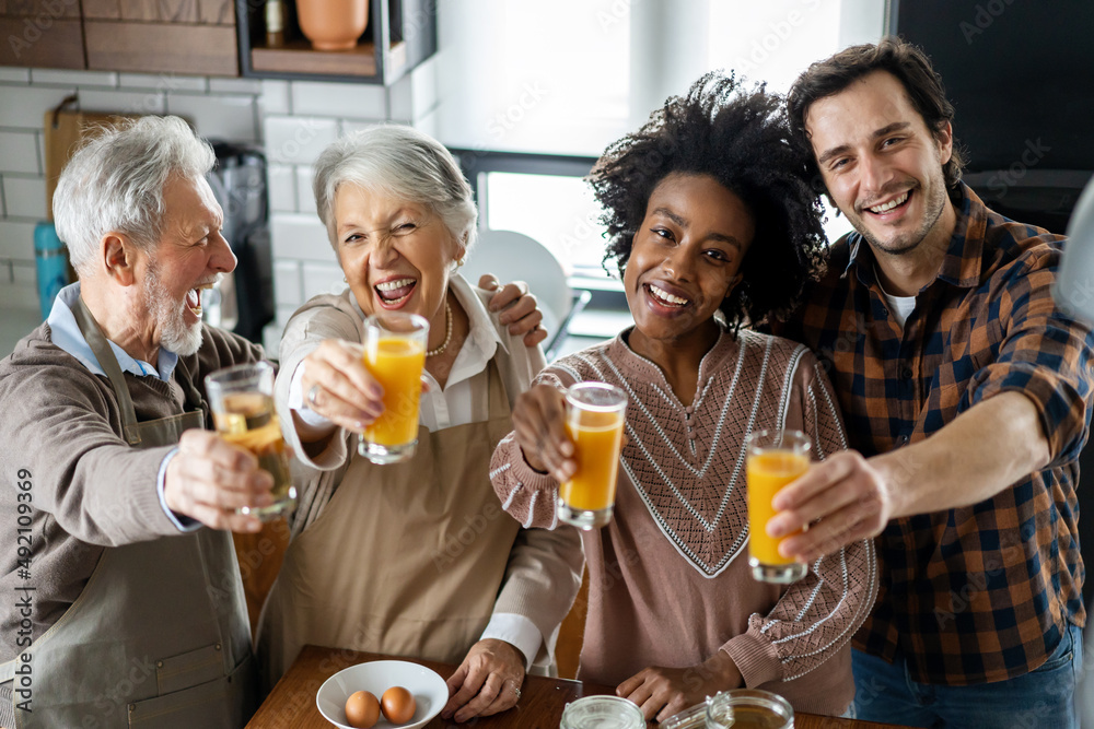 Multi Generation Family Enjoying Meal At Home Together