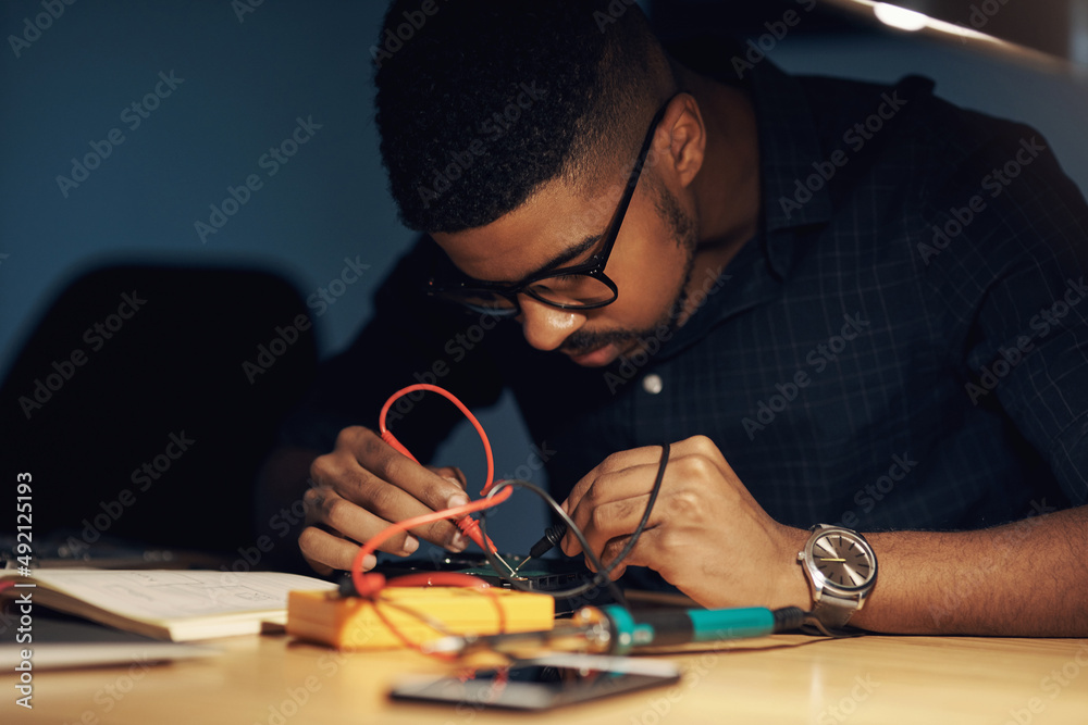 The expert to tackle any tech challenge. Shot of a young technician repairing computer hardware.