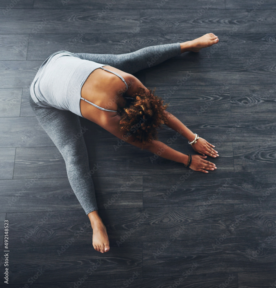 Its yoga time. High angle shot of a young woman practising yoga.