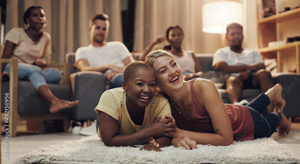 Movies night with the besties. Shot of a group of a diverse group of friends relaxing in the lounge 