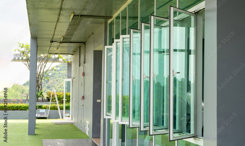 Window of fitness on the roof top of condominium , window near green grass field