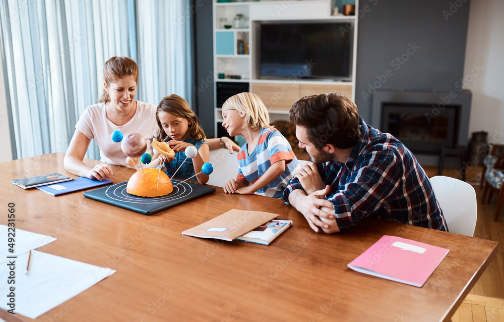 Shes going to take over the world one day. Shot of a beautiful young family working together on a sc