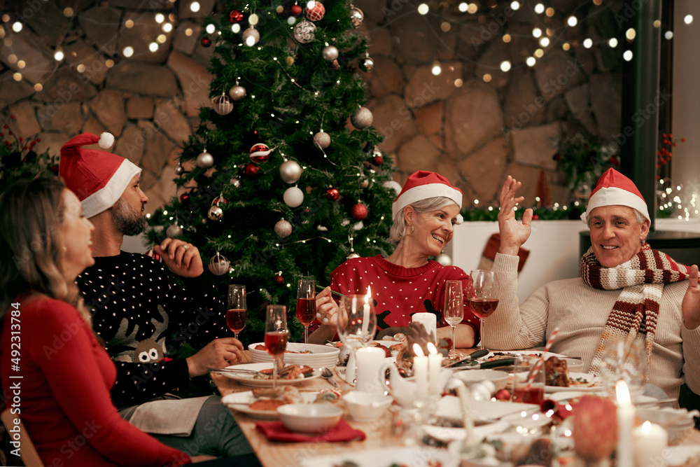 Is it time to open the presents yet. Cropped shot of a cheerful family having dinner together on Chr