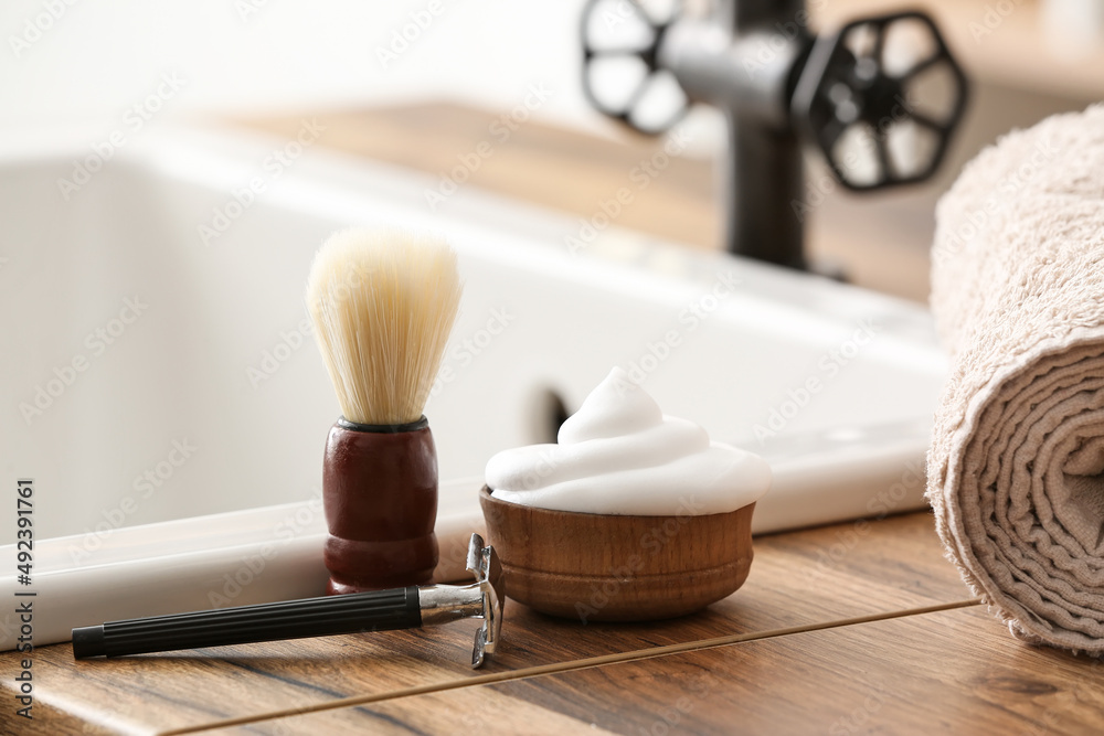 Male accessories for shaving on table in bathroom