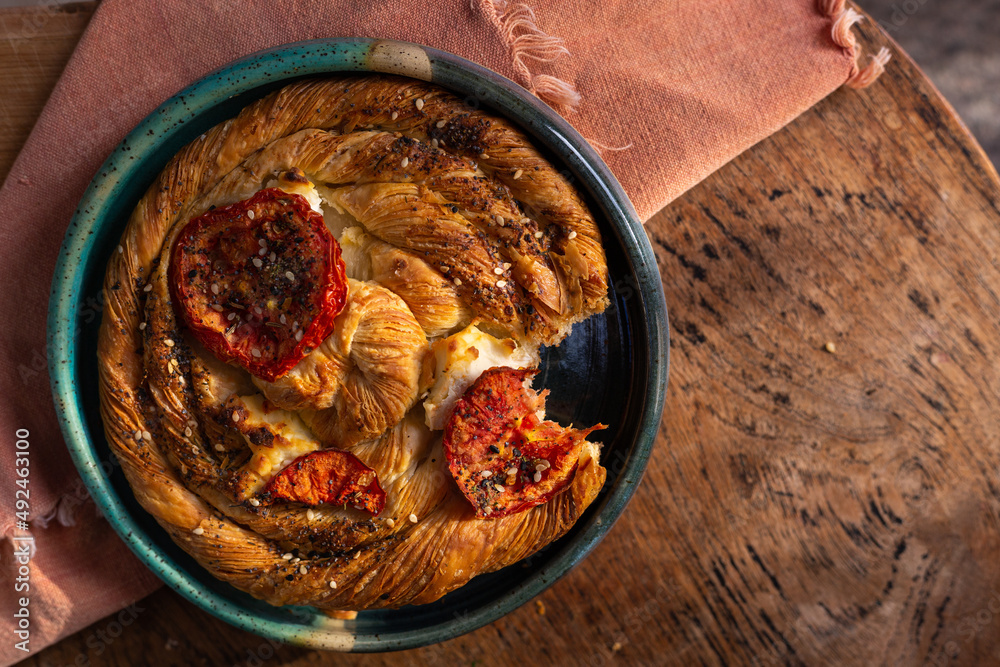 Breakfast pastry in the morning sunshine on a wood board