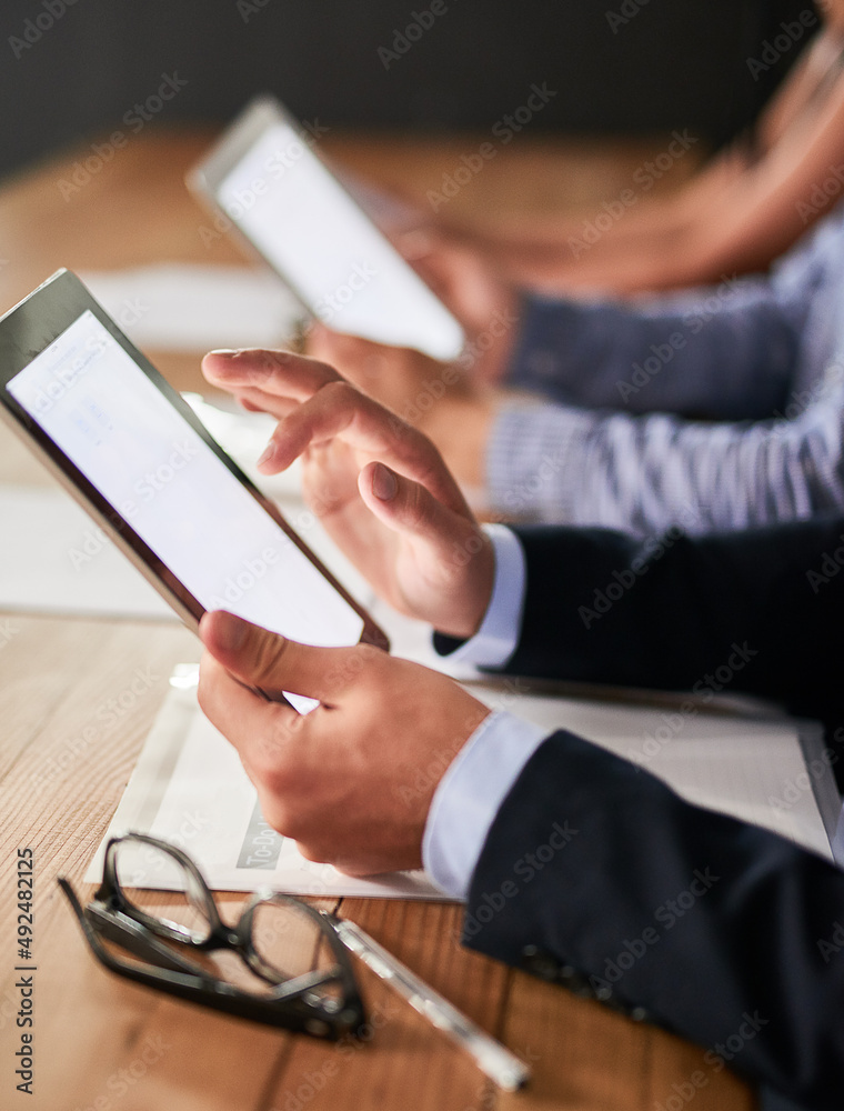 Accessing the business network with a single touch. Closeup shot of businesspeople using digital tab