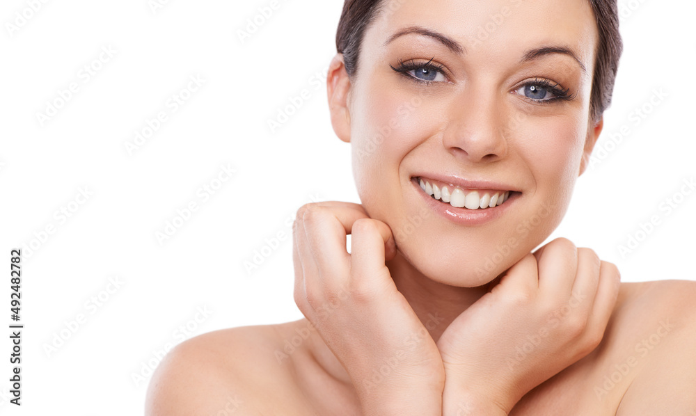 Naturally radiant. A beautiful young woman smiling at the camera while holding her face in her hands