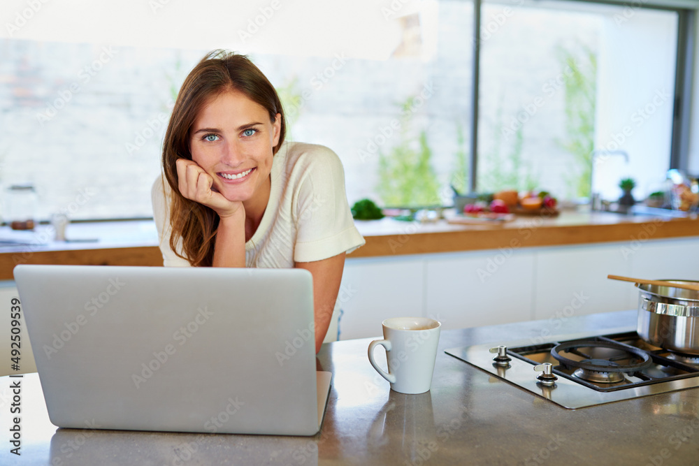 Ive found hundreds of menu ideas. Portrait of an attractive young woman using her laptop in the kitc