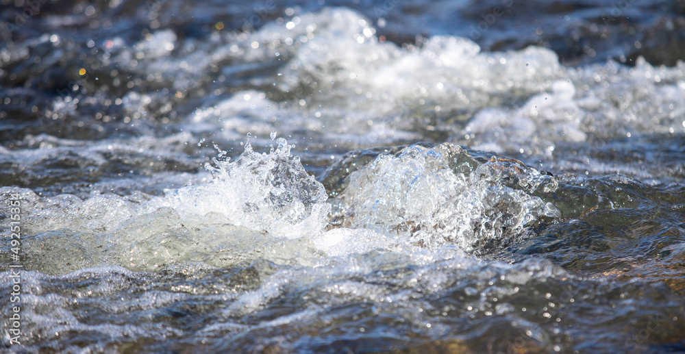 Water runs over the stones, early spring nature.