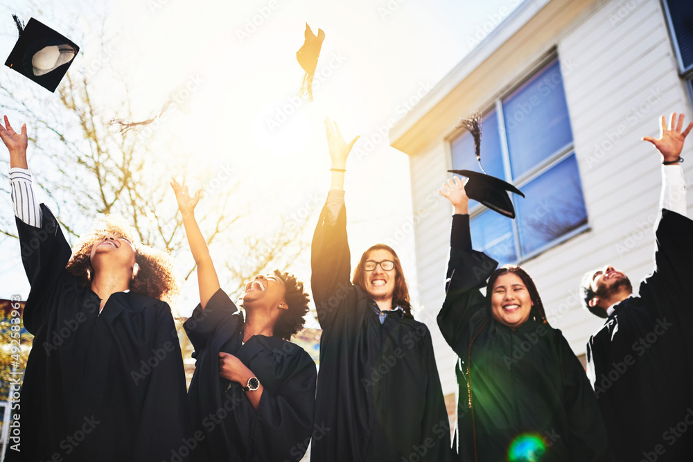 Hats off to ourselves. Cropped shot of a group of students throwing their caps into the air after gr