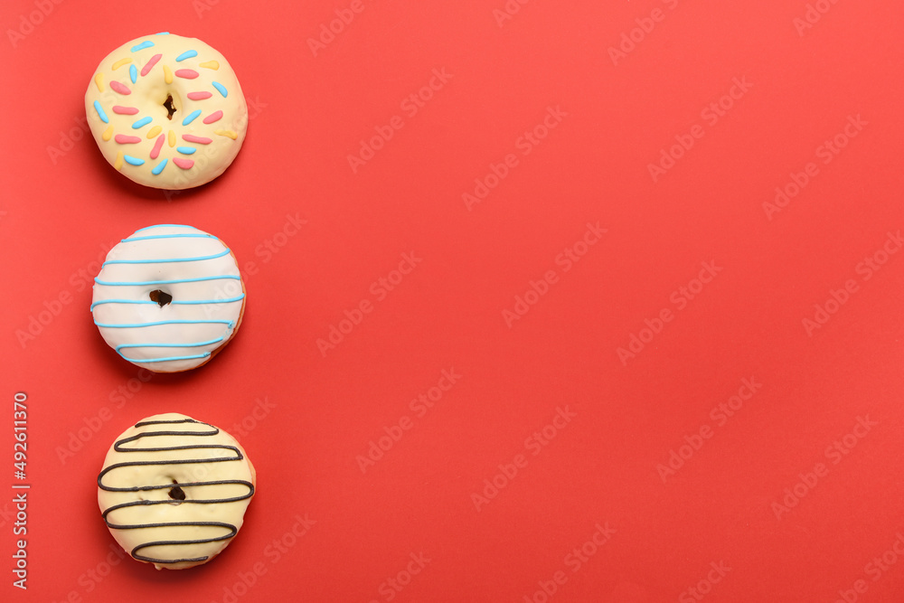 Different sweet donuts on red background