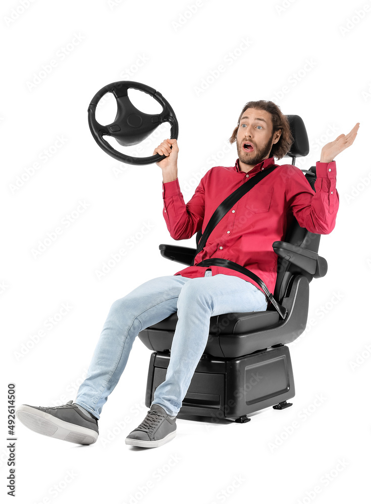 Shocked man in car seat and with steering wheel on white background