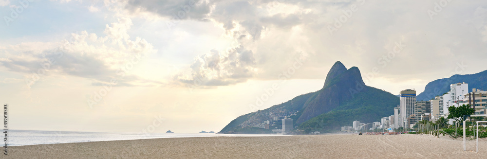 Sunset over paradise. Shot of a rio beach with the sun setting.