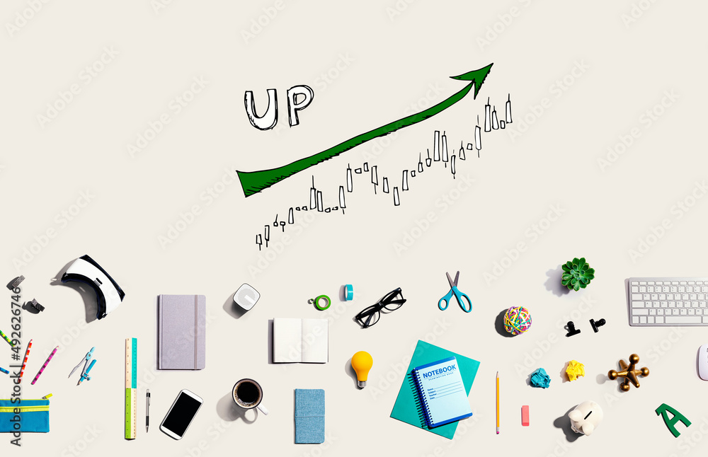 Market up trend chart with collection of electronic gadgets and office supplies