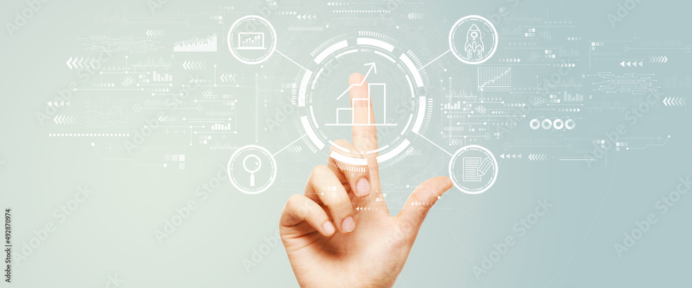 Business growth analysis with hand pressing a button on a technology screen