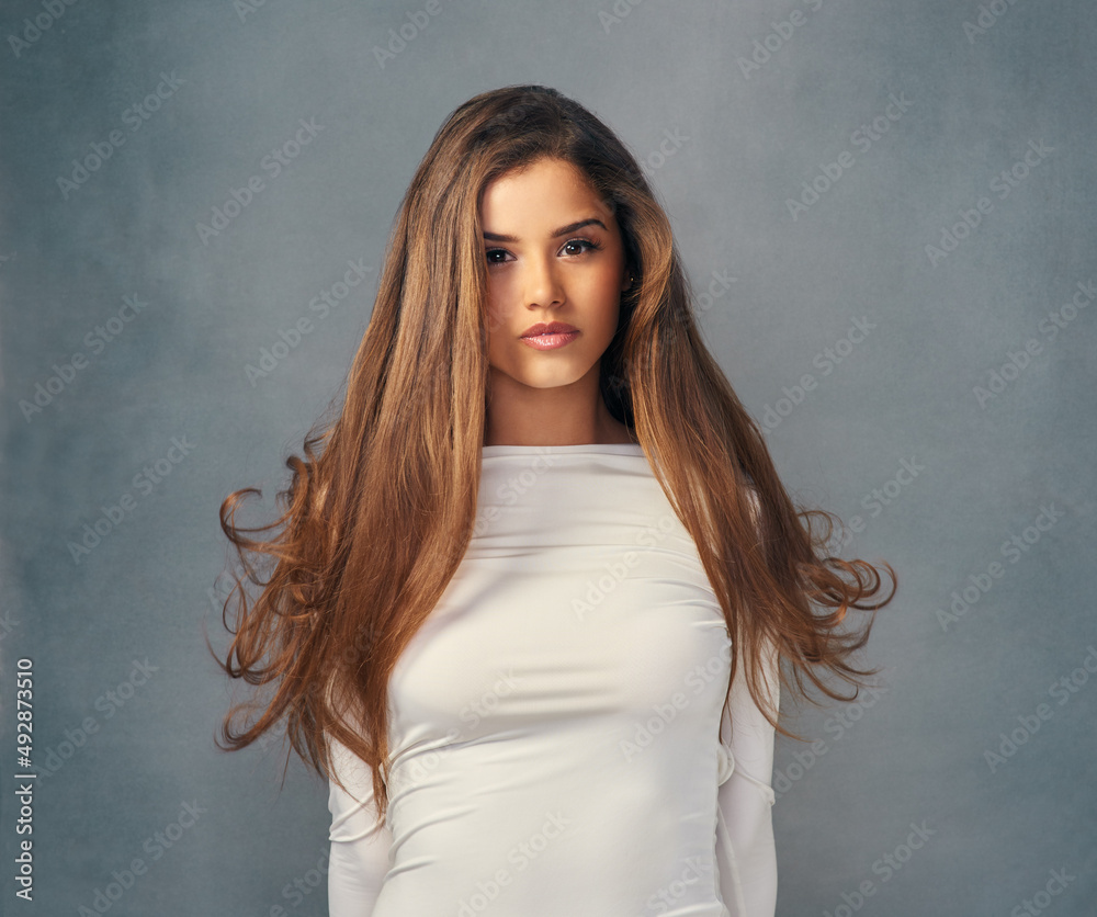 True beauty is owning who you are. Studio portrait of an attractive young woman posing against a gre