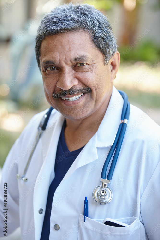 Being a doctor is so fulfilling. Cropped portrait of a male doctor smiling happily outside.