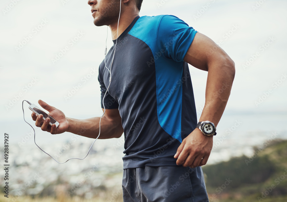 Hes got the perfect track for running. Cropped shot of a young man running outdoors.