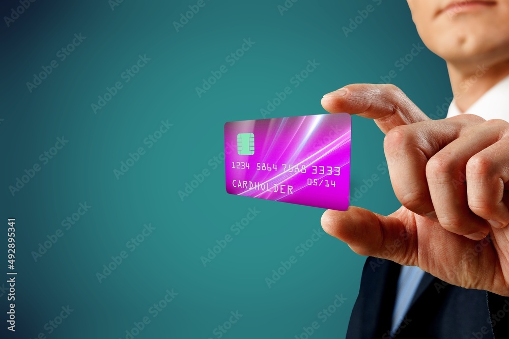 Human hand holds levitating template mockup Bank credit card with online service