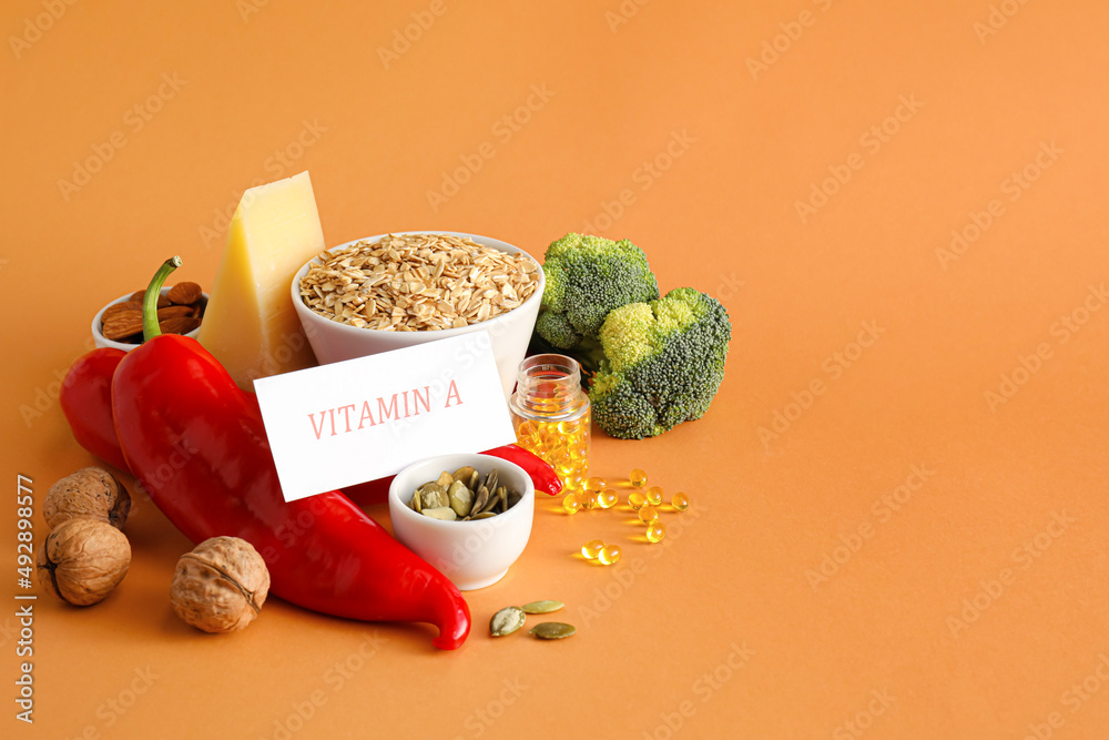 Set of healthy products rich in vitamin A on color background