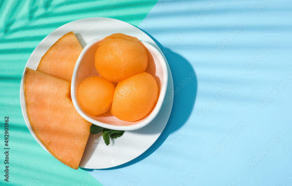 Bowl with tasty melon sorbet on blue background