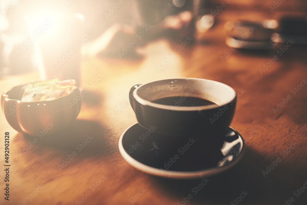 Better coffee you will not find. Shot of a cup of freshly brewed coffee on a wooden table of a resta