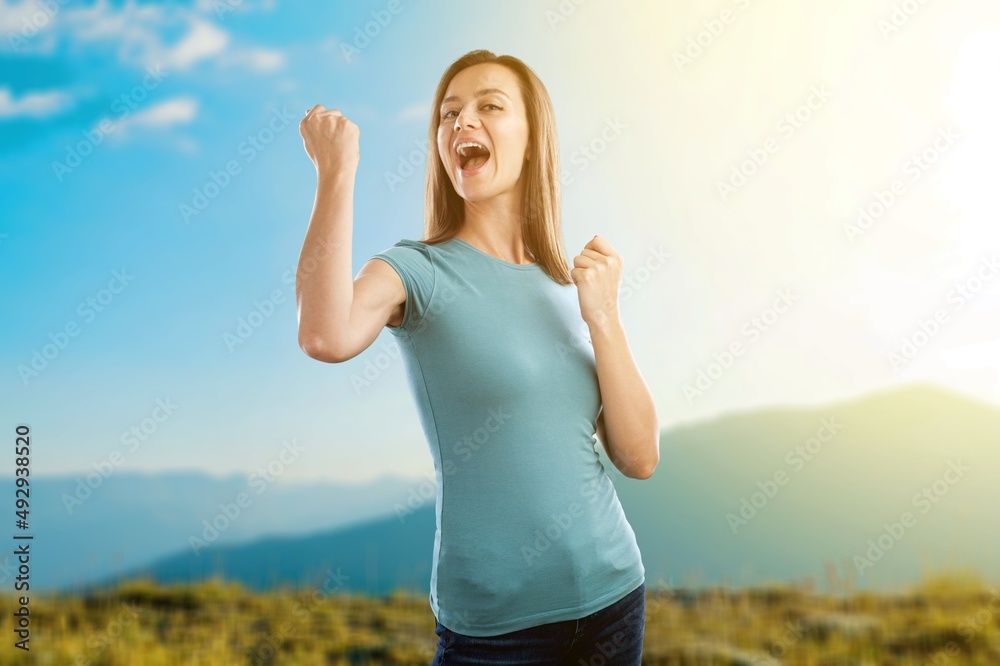 Overjoyed happy woman enjoying the green beautiful nature, healthy natural lifestyle