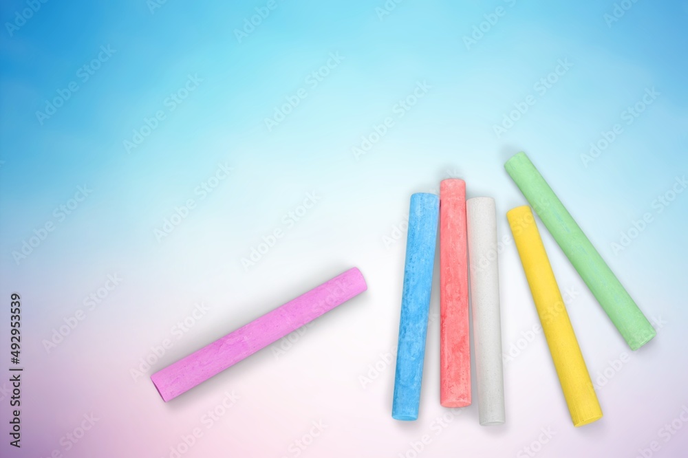 Stack of colored chalk on background