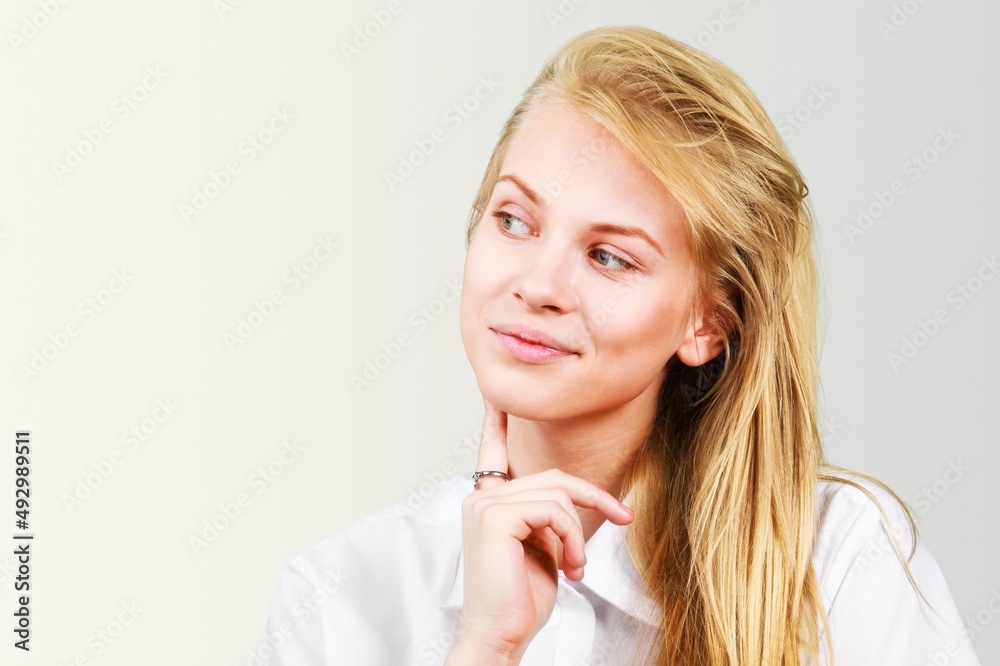 Photo of serious young woman to concentrate considers something contemplates about important thing.