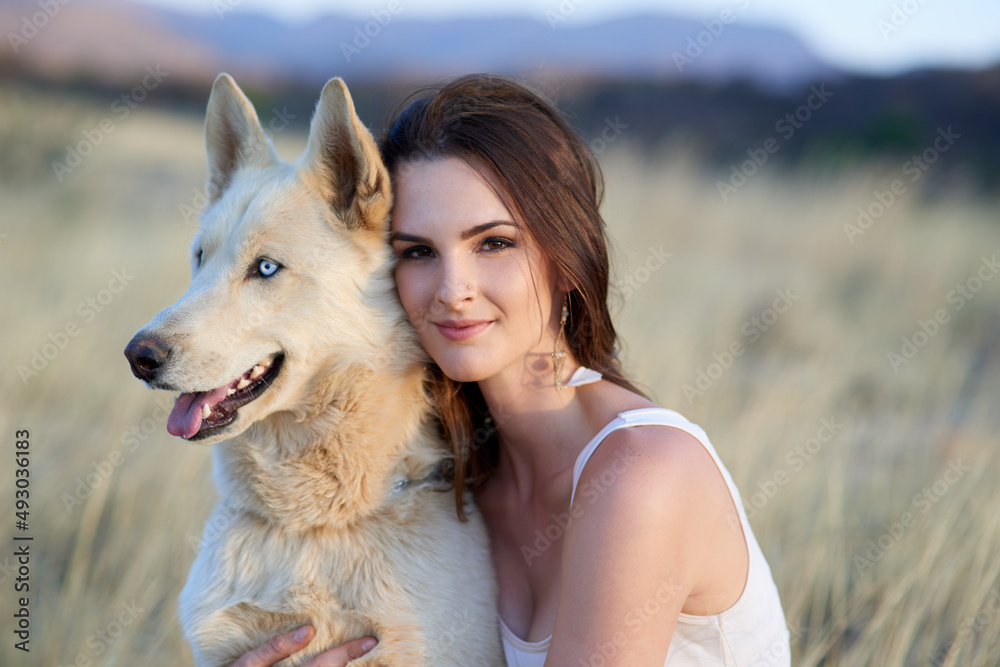 Hes so doggone cute. Portrait of an attractive young woman bonding with her dog outdoors.