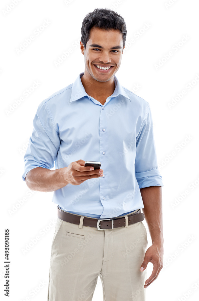 Hes always making plans. Studio shot of a young man text messaging isolated on white.