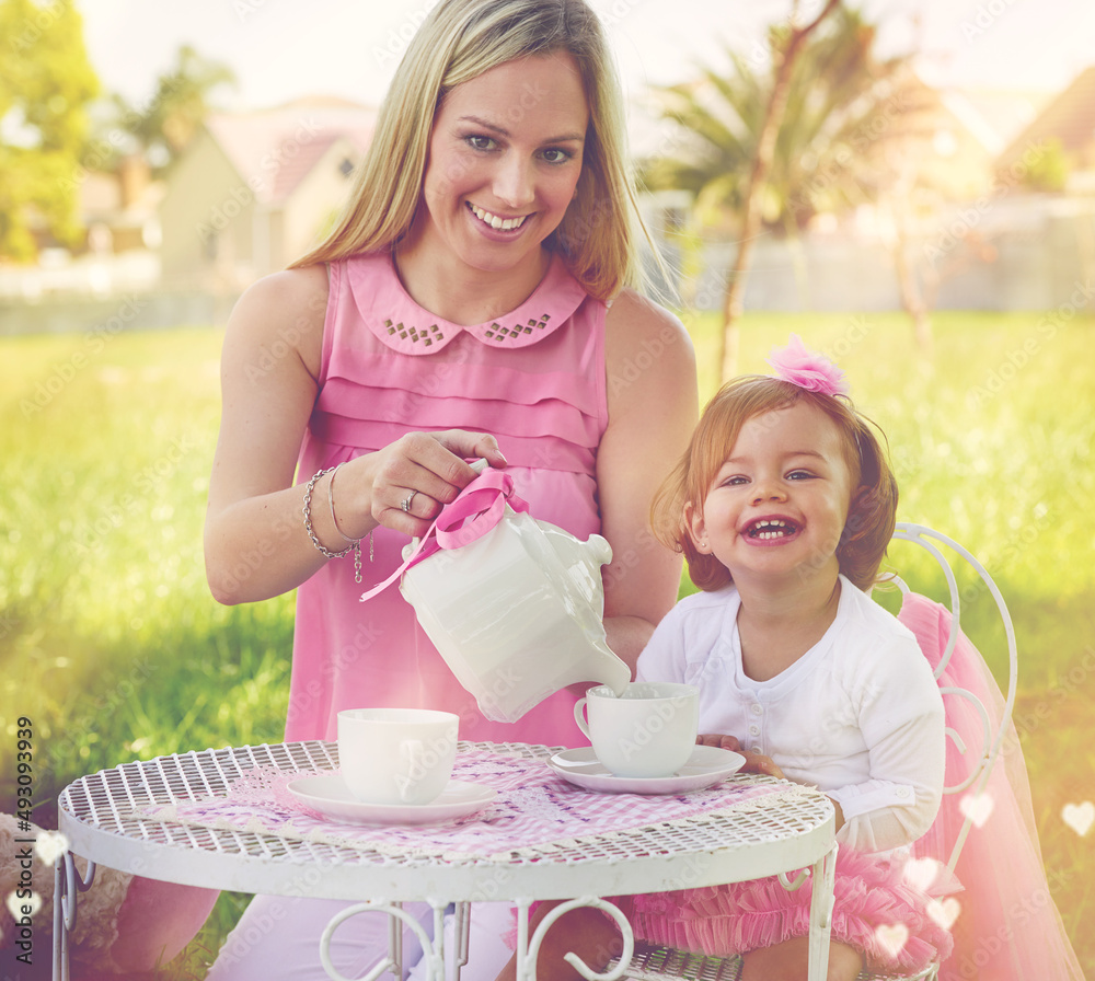 Im raising a little lady. Portrait of a mother and her cute little girl having a tea party on the la