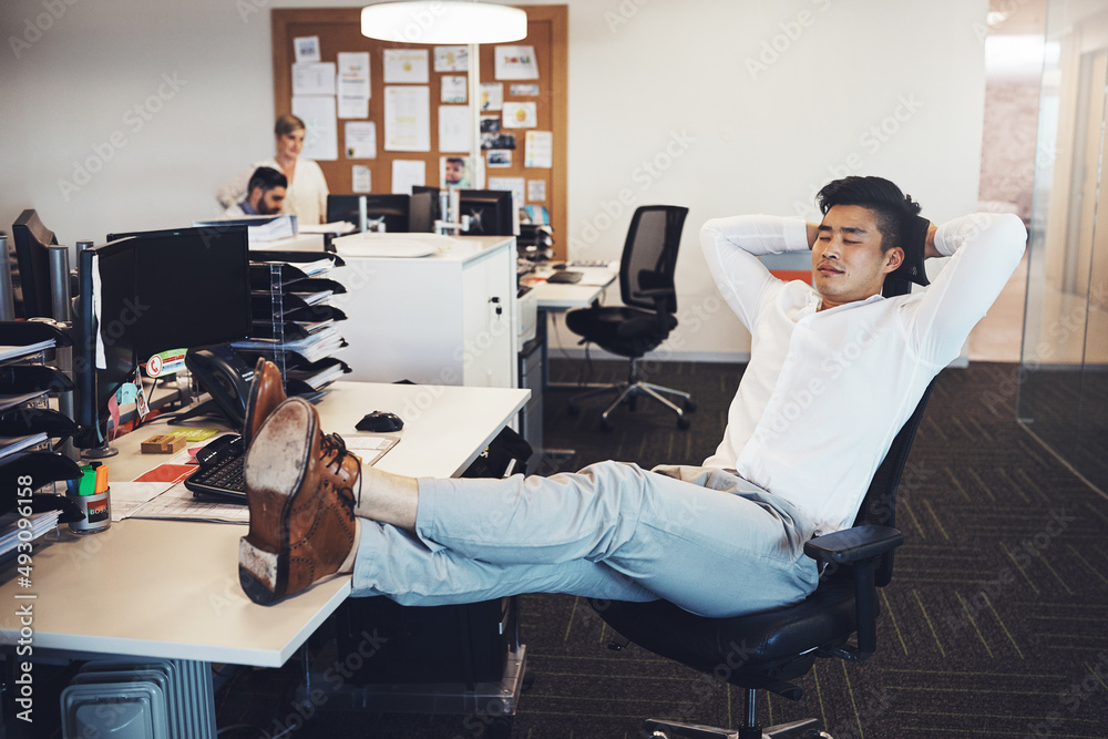 Time to take a break. Shot of a businessman taking a break in the office.