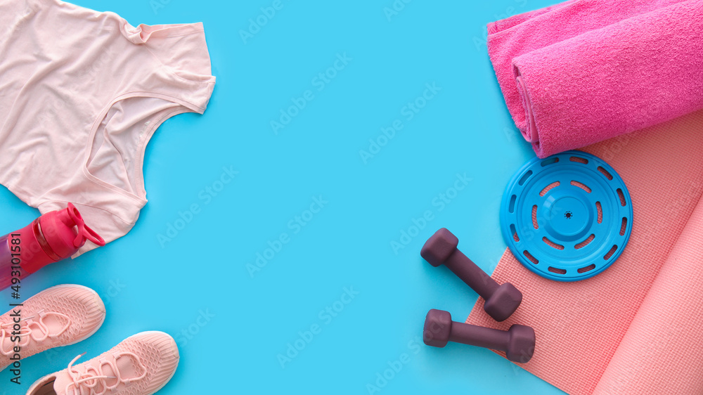 Different sports equipment, shoes, t-shirt and towel on color background