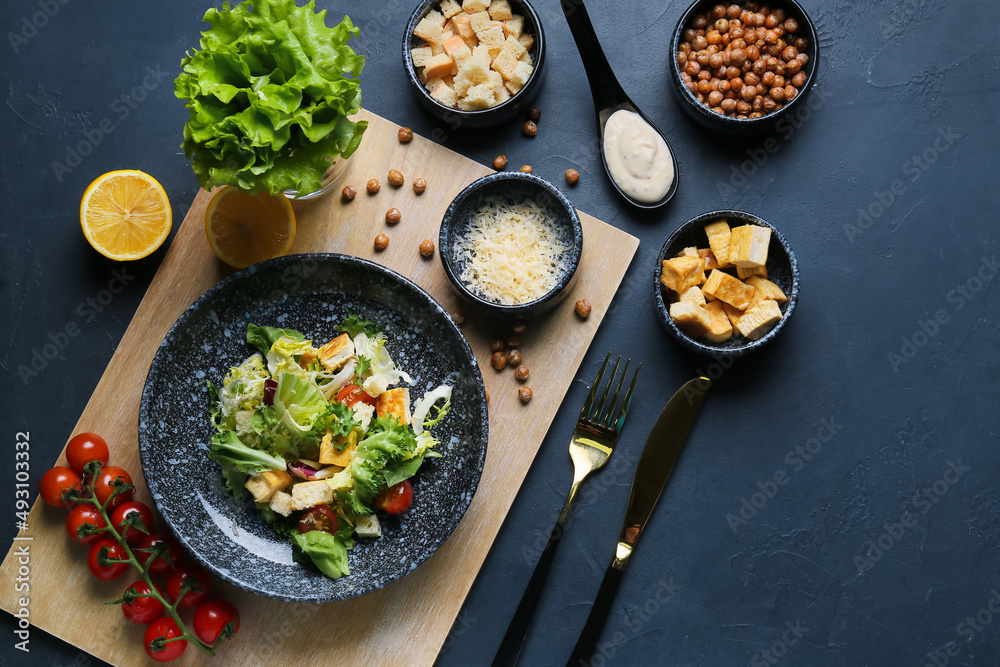 Composition with tasty vegan Caesar salad on dark background