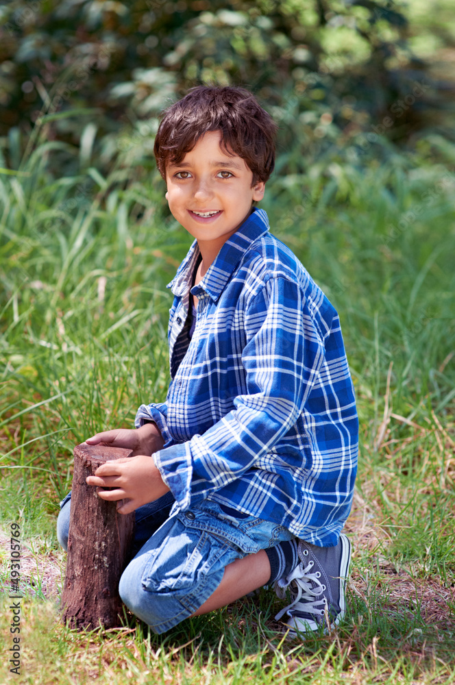 He really loves Nature. A young boy playing outside.