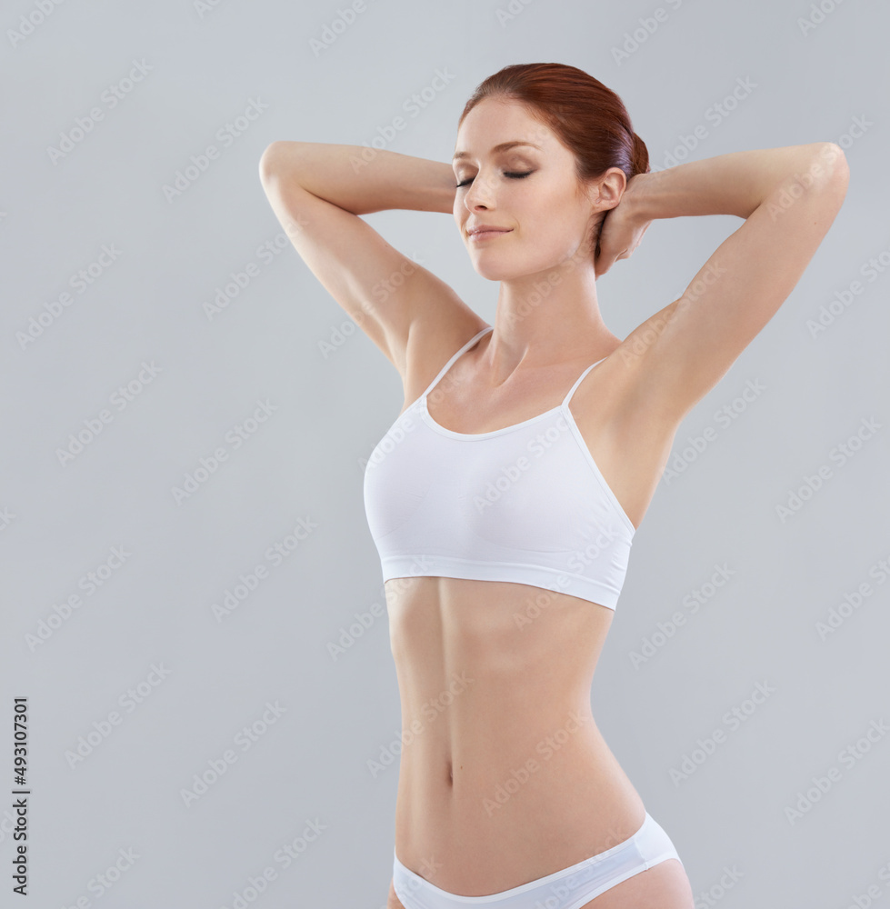 Feeling good after her diet. Cropped shot of a sporty young woman in the studio.