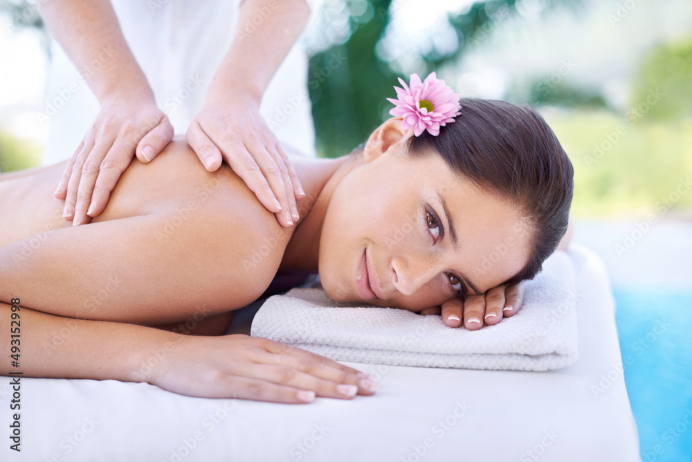 Feeling so pampered. Shot of an attractive young woman,getting a back massage at a spa.