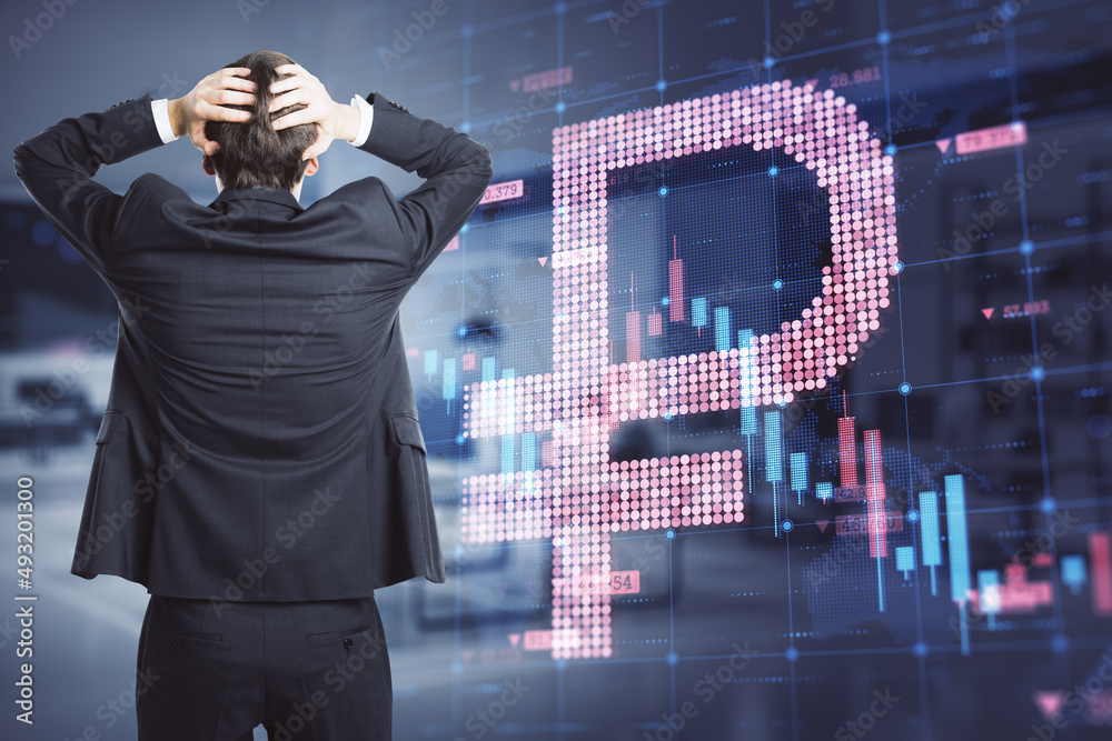 Back view of worried young businessman with abstract glowing falling forex chart with dollar sign on