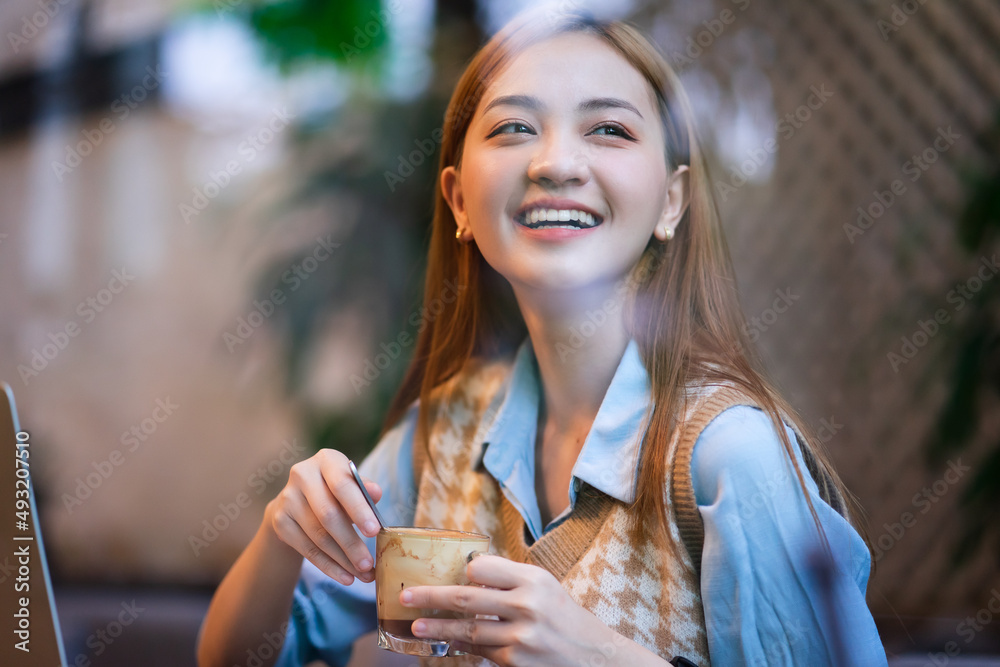 Young Asian business woman working at coffee shop